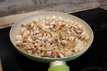 
Fried mushrooms champignons in a pan.