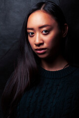 pretty young asian girl posing sensitive on black background, lifestyle people concept