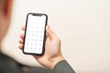 Businessman holding digital tablet in man hands, browsing internet or application with blank screen mock-up for your design at home office with blurry background with free space for custom text
