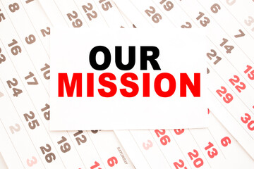 text OUR MISSION on a sheet from Notepad.a digital background. business concept . business and Finance.