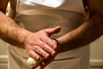 Fototapeta premium Preparing bread for homemade pizza, an Italian tradition