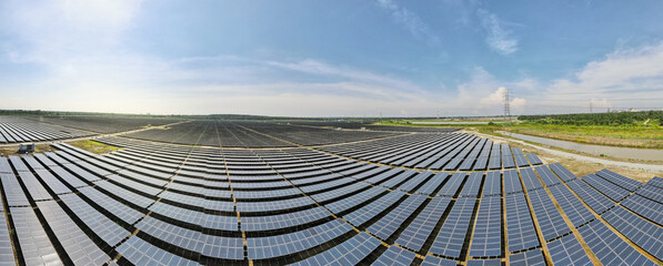 Aerial view of a new solar farm. Rows of modern photovoltaic solar panels farm. Renewable ecological source of energy from the sun. Aerial view.