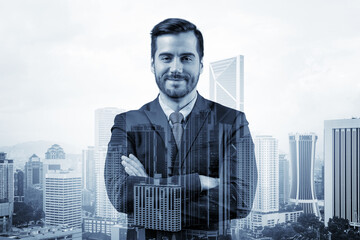 Prosperous European entrepreneur in suit in crossed arms pose. Kuala Lumpur cityscape. The concept of problem solving. KL skyscrapers. Double exposure.