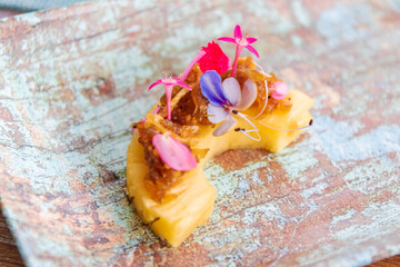 Sweet and sour fruit (pineapple) slices served with a nutty, sweet-savory peanut sauce called Mahor; Royal Thai Canape.
