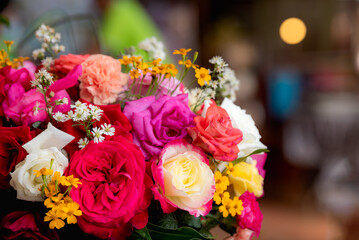 Colorful roses in rose flower bouquet with bokeh background.