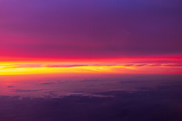 Dramatic sunset sky with clouds. Skyscraper background view seen from the plane.