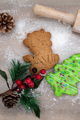 New Year's gingerbread bull and Christmas tree, wooden rolling pin, lava branch on the table. Gingerbread cookies on the kitchen table. New Year's composition.