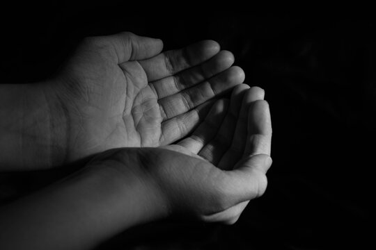 blank children hands held up in black white