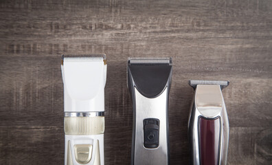 Hair clippers on the wooden background.