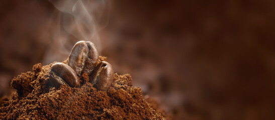 three aromatic roasted coffee beans on the ground and ready to brew coffee in jets of steam