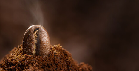 aromatic roasted coffee beans on ground and ready to brew coffee in jets of steam