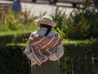 Old woman in andes town village Achoma wearing traditional indigenous handwoven colorful dress...