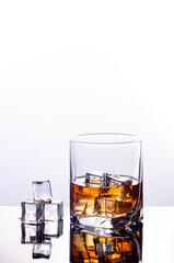 Single malt whiskey with ice isolated on white