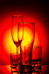 set of wine and beer glasses on a red and black gradient background