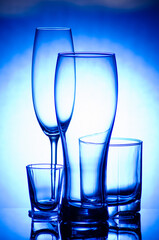 set of wine and beer glasses on a blue gradient background