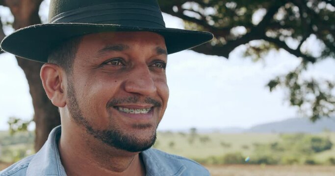 Brazilian farmer man stand at the green farm with happy and smile. Latin farmer. 4K.
