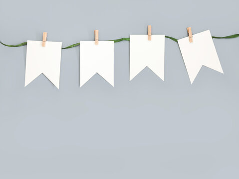 White paper garland cut against a bright beige wall background