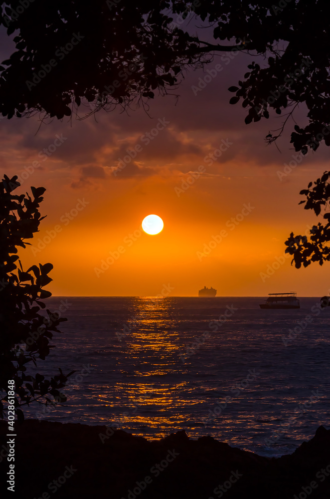 Wall mural Tropical orange sky sunset over the ocean in the islands o Hawaii. - Wall murals