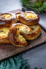 Curd cheesecakes. Baked yeast open pies Homemade cakes. Food on the table. Portioned pies. Cottage cheese and raisins for the filling. Cheesecake.