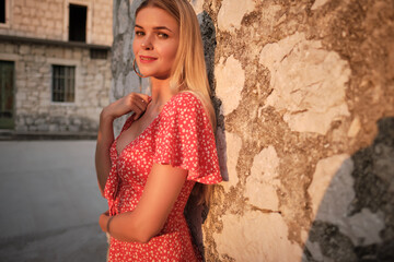 Fototapeta premium Traveling by Europe. Happy young woman in elegant dress walking by streets , Croatia.
