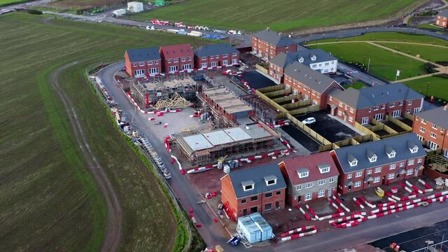 Housing development in the UK. Building site for home next to grassy fields. 

Drone 

4K 25fps 10bit blog-rec709.
