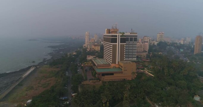 A drone shot at Bandra Worli Sea Link seen from an aerial view in slow motion. Cinematic drone movement with the iconic Mumbai Sea Link at the forefront and the city view in the background.