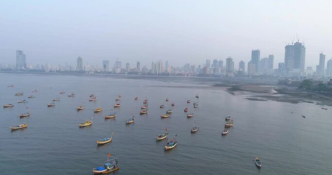 A drone shot at Bandra Worli Sea Link seen from an aerial view in slow motion. Cinematic drone movement with the iconic Mumbai Sea Link at the forefront and the city view in the background.