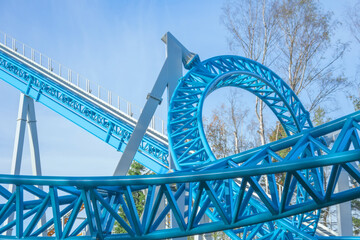 Roller Coaster loops in funny amusement park.
