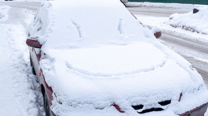 Fototapeta premium smile on a snow-covered car in the snow