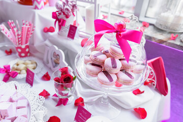 French macaroons on a pink wedding candy bar