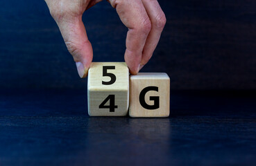 Time to 5G. Male hand turns a wooden cube and changes sign 4G to 5G. Technology, business, network,...