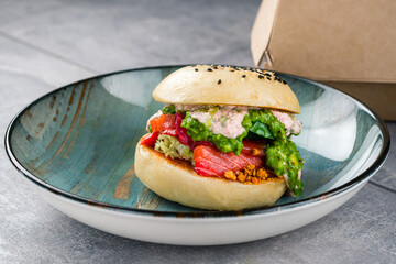 Delicious and juicy hamburger with recyclable paper burger box for takeaway food, still life and mock up