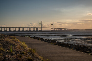 Fototapeta premium Golden Hour at the The Prince of Wales Bridge and the River Severn, seen from Redwick, South Gloucestershire, England, UK