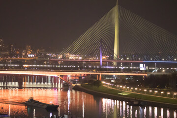 Fototapeta na wymiar New so called Bridge over the Ada in Belgrade, capitol of Serbia. Beautiful night view on panoramic Belgrade 