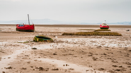 Boats in the low tide, with Morecambe Bay in the background, seen from Marine Rd in Morecambe,...