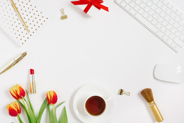 Flat lay Valentines Day background with computer keyboard, gift, notebook and red tulip top view white copy space. Spring and Mother Day