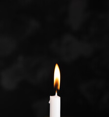 burning candle in the dark