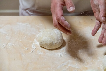 Preparing bread for homemade pizza, an Italian tradition