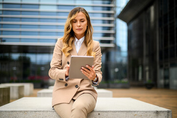 Smiling businesswoman using a digital tablet outdoor