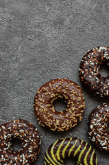 Chocolate donuts on dark. Delicious desserts.