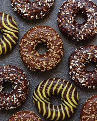 Chocolate donuts on dark. Delicious desserts.