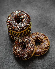 Chocolate donuts on dark. Delicious desserts.