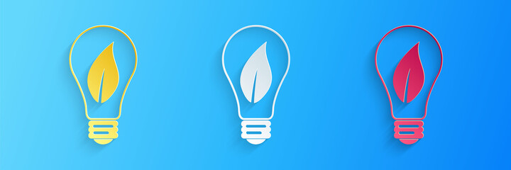 Paper cut Light bulb with leaf icon isolated on blue background. Eco energy concept. Paper art style. Vector.
