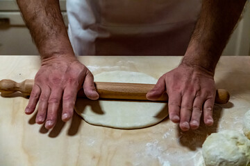 Preparing bread for homemade pizza, an Italian tradition