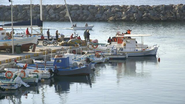 Syrian refugees arrive floating into local Greek harbor coming from Turkey on dangerous Aegean sea crossing in rubber raft.