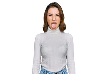Young caucasian girl wearing casual clothes sticking tongue out happy with funny expression. emotion concept. © Krakenimages.com
