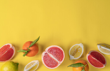 Citrus Fruits. Oranges,grapefruit,mandarin and Lemon on yellow background,Still life.Creative photography.Food background.