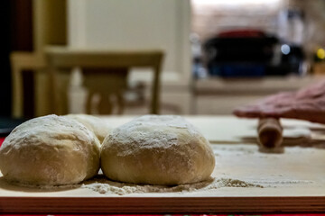 Preparing bread for homemade pizza, an Italian tradition