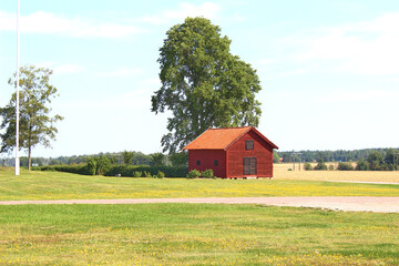 Obraz premium Red old country house with garden