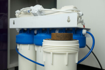 Dirty water filter cartridge used . Domestic water osmosis system at kitchen. Ecology, clean water, concept water treatment.